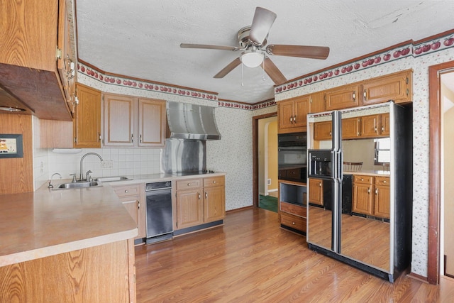 kitchen featuring ceiling fan, sink, a textured ceiling, decorative backsplash, and light wood-type flooring