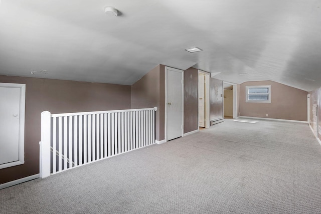 bonus room with light carpet, a baseboard radiator, and lofted ceiling