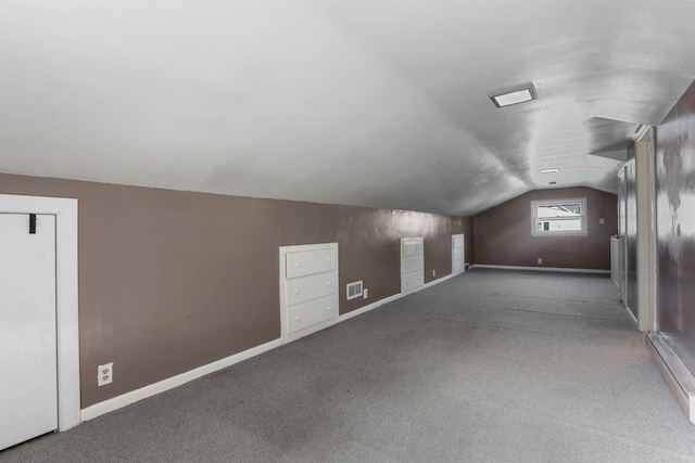 bonus room with carpet floors and vaulted ceiling