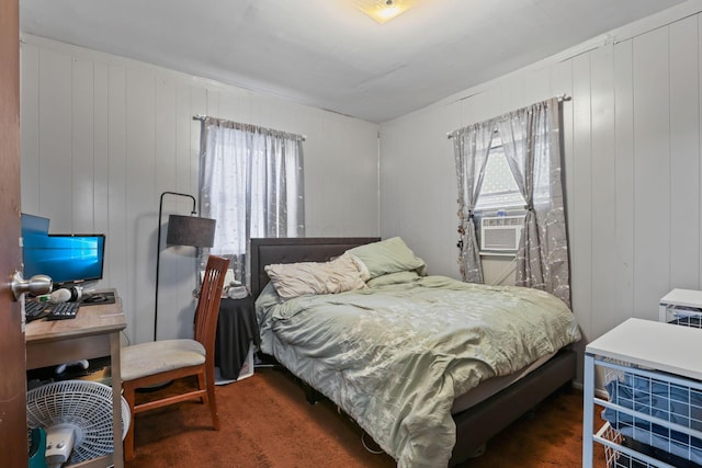 carpeted bedroom featuring wooden walls and cooling unit