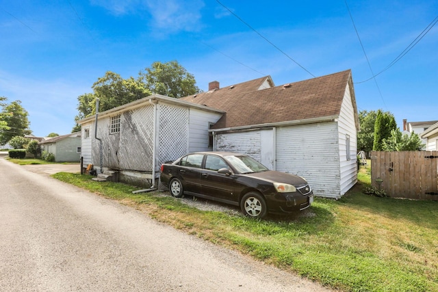 view of side of home featuring a yard