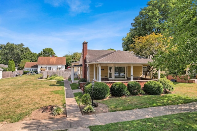 view of front of property with a front yard and a porch