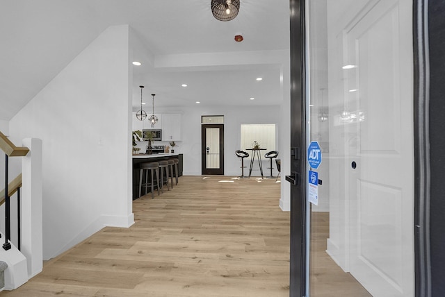 hallway featuring french doors and light hardwood / wood-style flooring