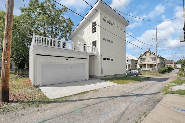 exterior space with a garage and a balcony