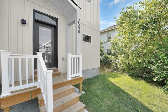 property entrance featuring a lawn