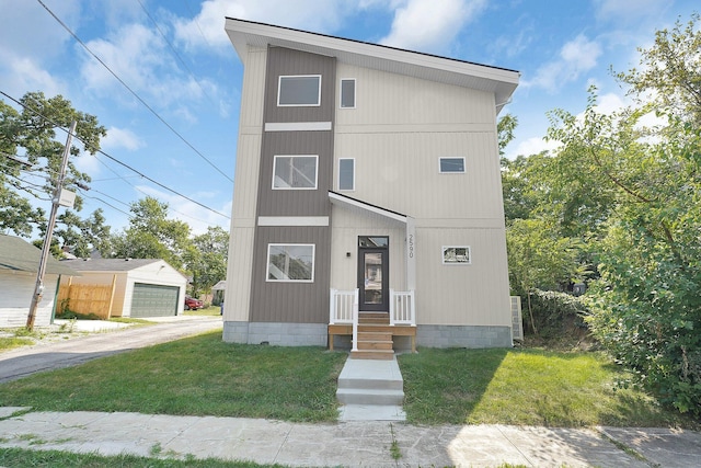 view of front facade with an outbuilding and a front lawn