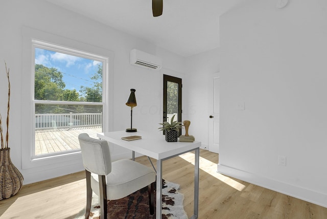 interior space with light hardwood / wood-style floors, a wall unit AC, and a wealth of natural light