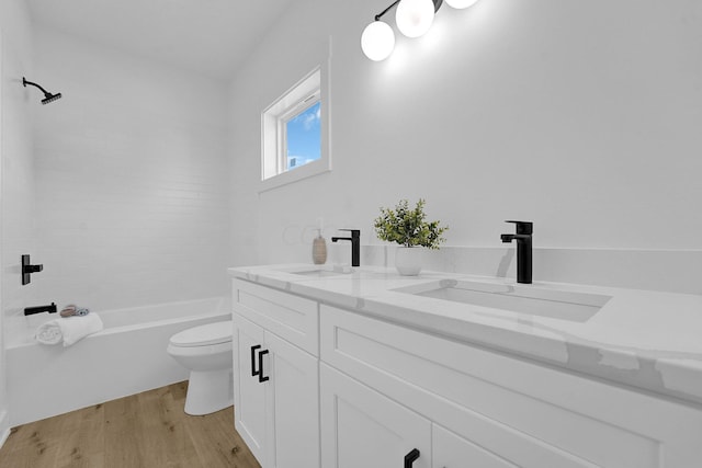 full bathroom with vanity, hardwood / wood-style flooring, toilet, and shower / bathtub combination