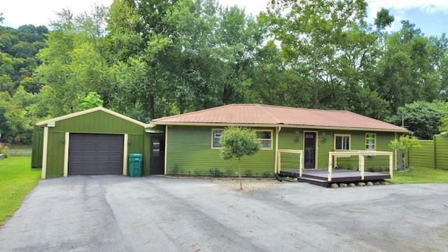 view of front of home with an outbuilding, a garage, and a wooden deck