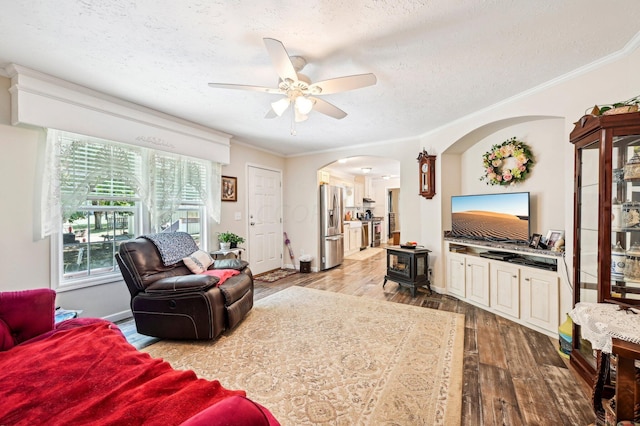 living room featuring ceiling fan, hardwood / wood-style floors, and ornamental molding