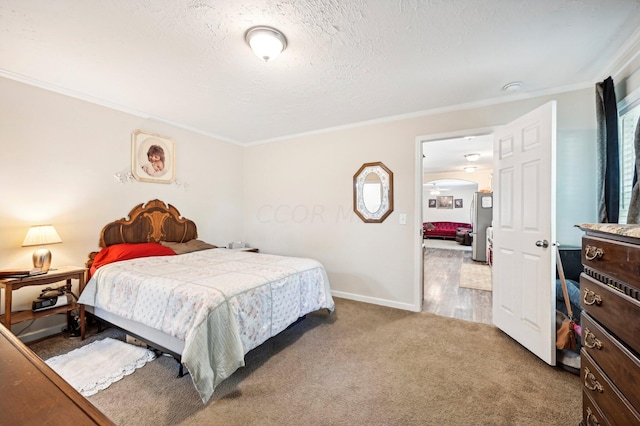 bedroom featuring crown molding, carpet, and a textured ceiling