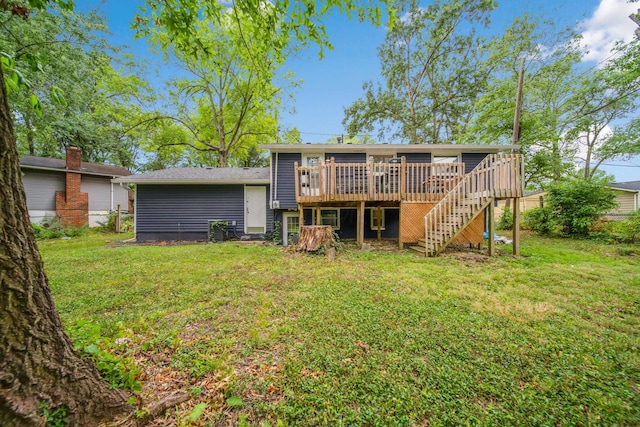 back of property with a lawn and a deck