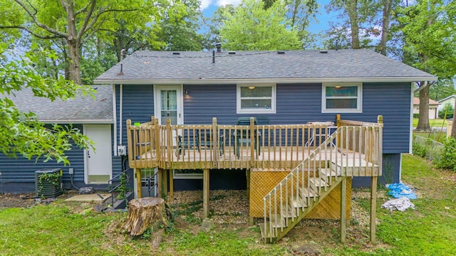 rear view of property featuring a wooden deck