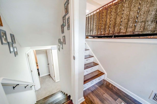 stairs featuring hardwood / wood-style floors