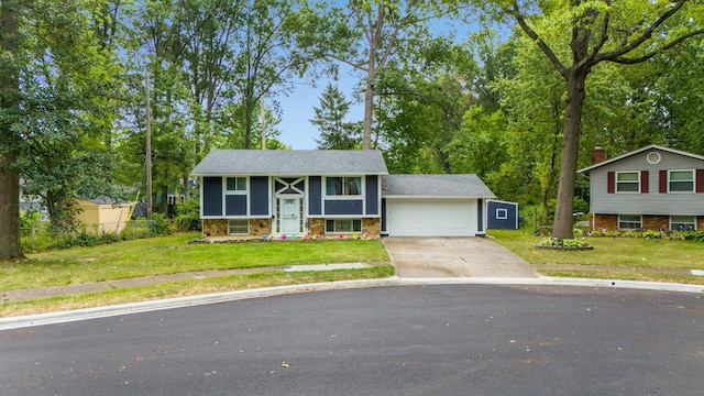 split foyer home featuring a front yard and a garage