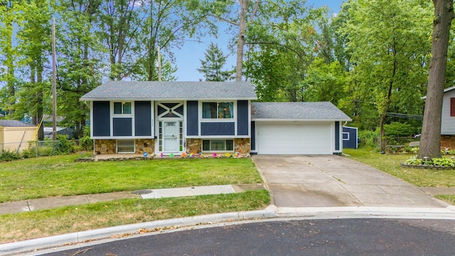 bi-level home with a garage and a front lawn