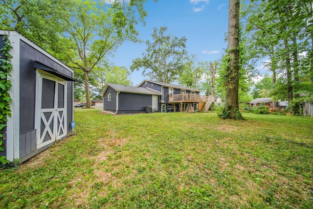 view of yard with a storage shed and a wooden deck