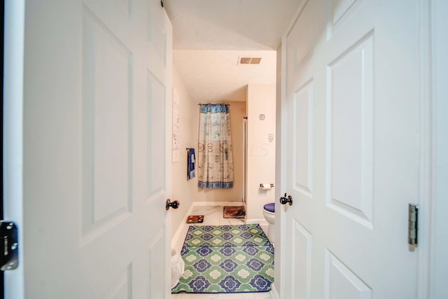 hall featuring tile patterned flooring