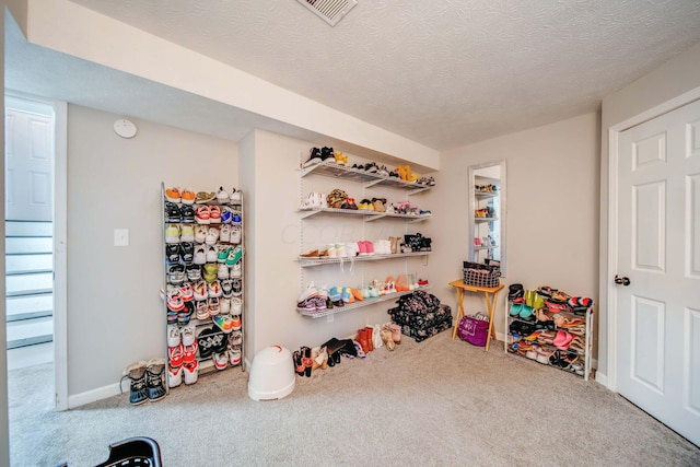 game room with carpet flooring and a textured ceiling