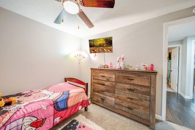 bedroom featuring a textured ceiling, ceiling fan, wood-type flooring, and vaulted ceiling