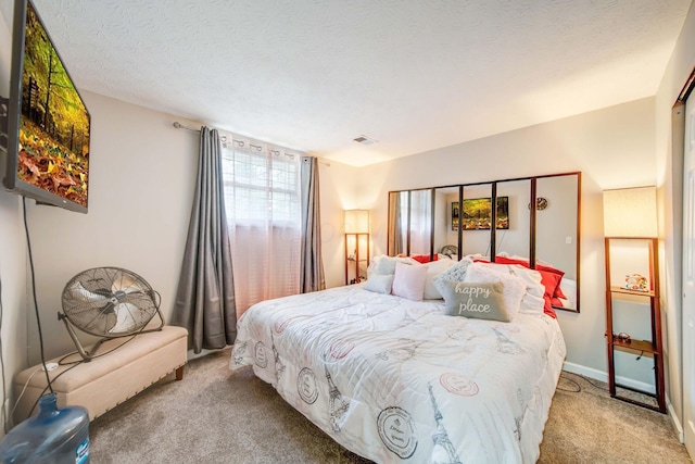 carpeted bedroom with a textured ceiling