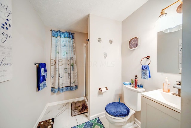 bathroom with a textured ceiling, vanity, toilet, and walk in shower