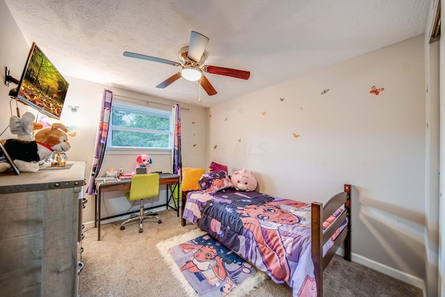 bedroom featuring ceiling fan, light colored carpet, and a textured ceiling