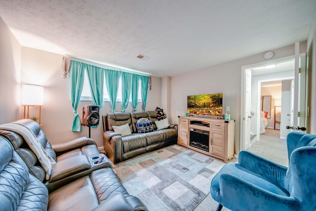 living room with light carpet and a textured ceiling