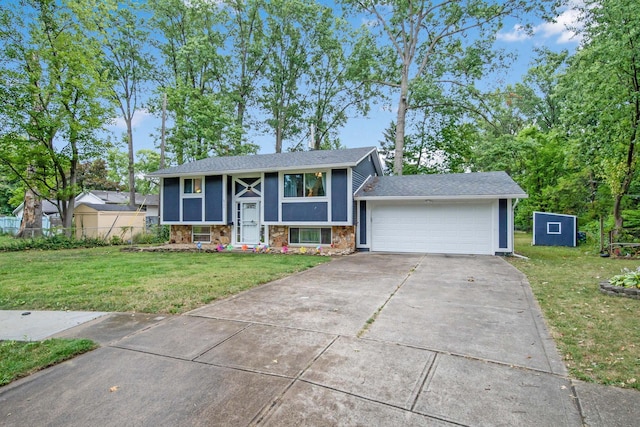 raised ranch featuring a garage and a front lawn