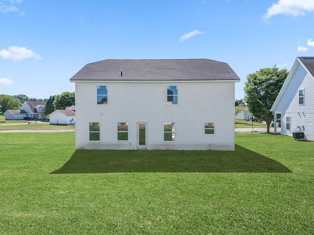 back of house with a lawn and cooling unit