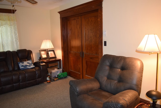 carpeted living room featuring ceiling fan