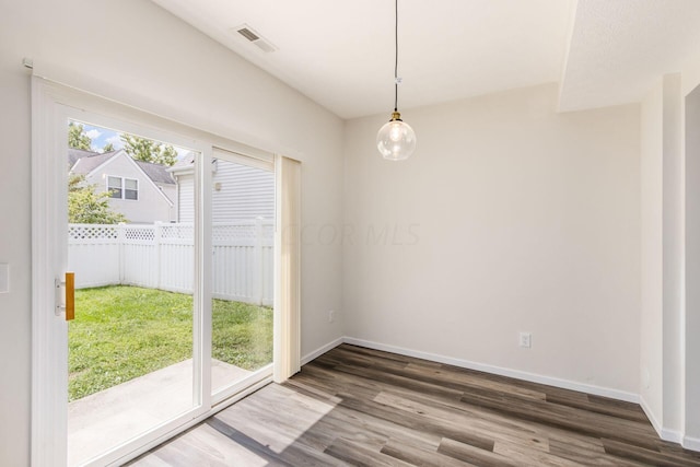 unfurnished dining area featuring hardwood / wood-style flooring