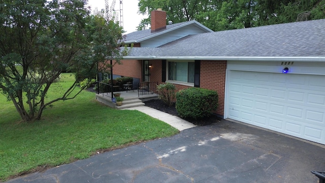 view of front of property featuring a garage and a front yard