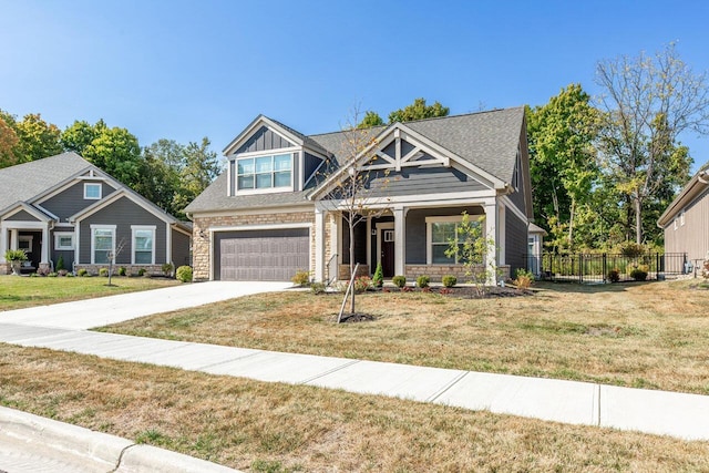 craftsman-style house with a garage and a front lawn