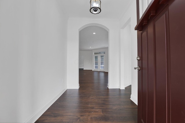 hallway featuring crown molding and dark hardwood / wood-style flooring