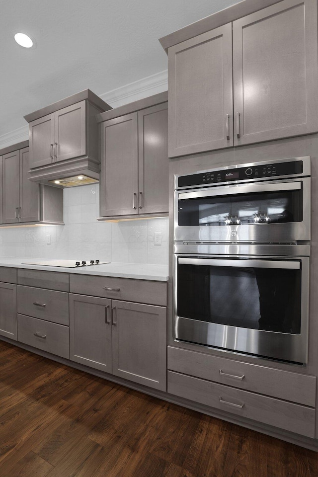 kitchen featuring crown molding, gray cabinets, and double oven