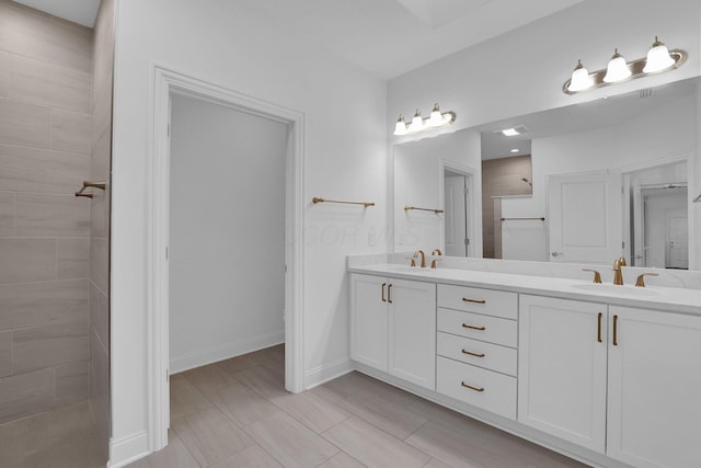 bathroom with vanity and tiled shower