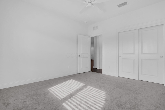 unfurnished bedroom featuring ceiling fan, carpet flooring, and a closet