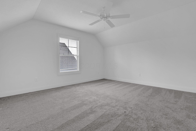 bonus room featuring lofted ceiling, carpet flooring, and ceiling fan