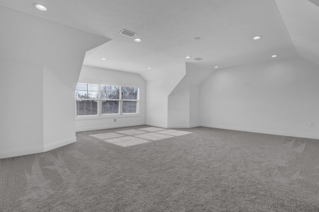 bonus room featuring lofted ceiling and light carpet