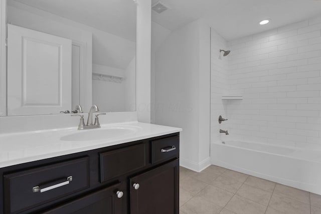 bathroom with tile patterned floors, tiled shower / bath combo, and vanity