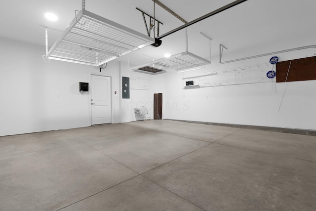 garage featuring a garage door opener and electric panel