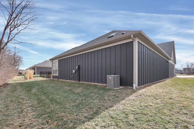 view of side of home with a lawn and central air condition unit