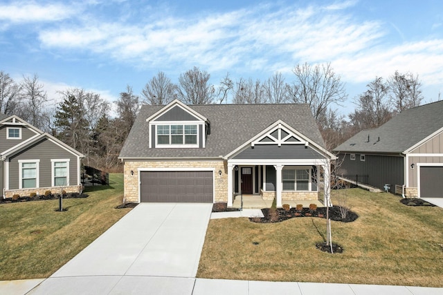 craftsman-style home with a garage, a front yard, and covered porch