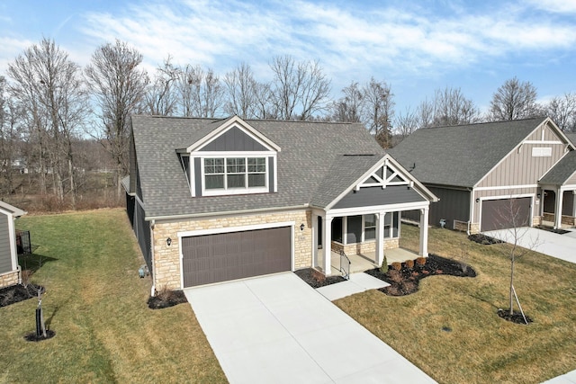 view of front of house with a garage, a front yard, and a porch