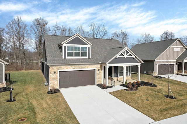 view of front of house featuring a garage, covered porch, and a front lawn