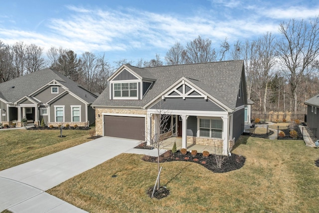 craftsman house with a garage, a front yard, and covered porch