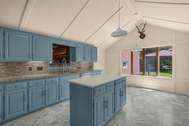 kitchen featuring sink, dishwasher, hanging light fixtures, blue cabinets, and backsplash