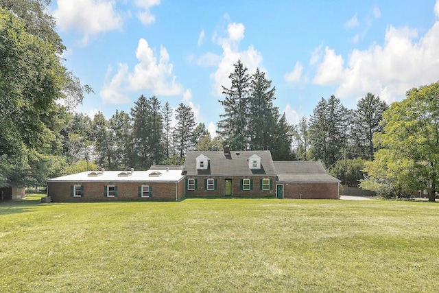 new england style home featuring a front yard