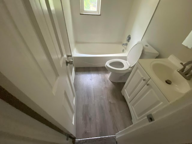 full bathroom with hardwood / wood-style floors, vanity, toilet, and shower / bathing tub combination